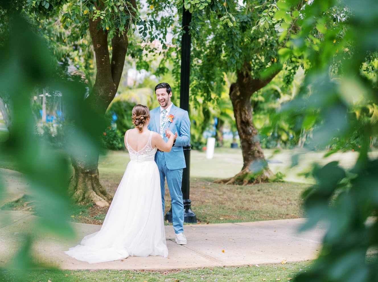 bride-groom-facing-each-other-near-lush-landscape