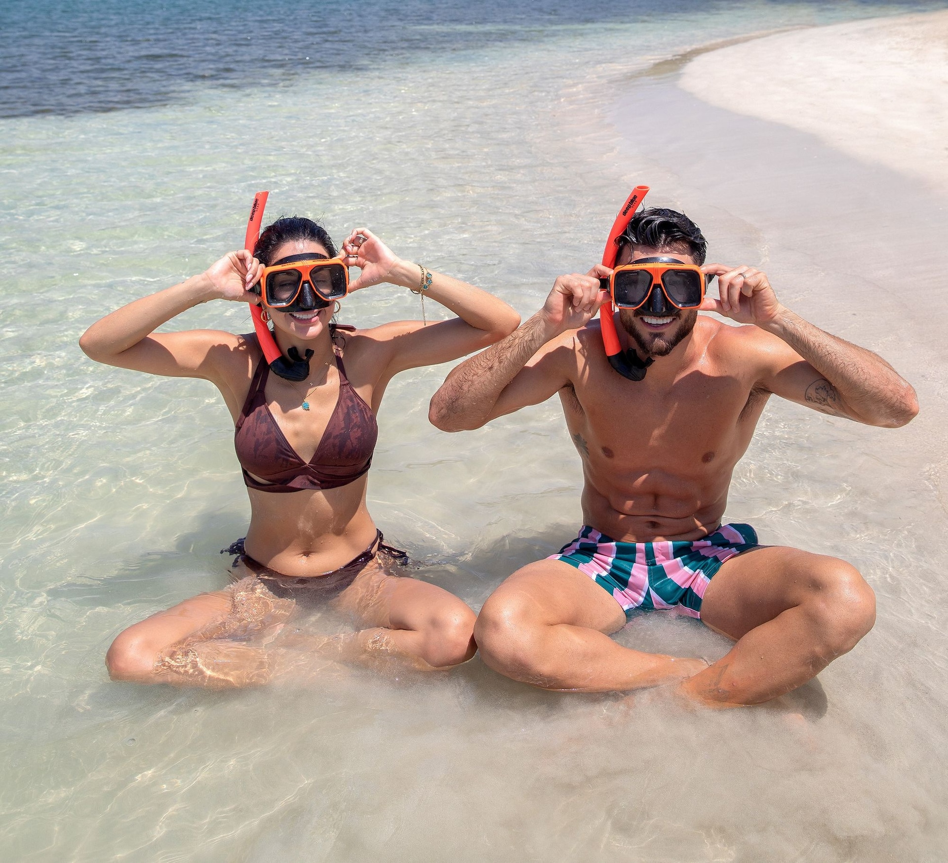 couple snorkeling on beach