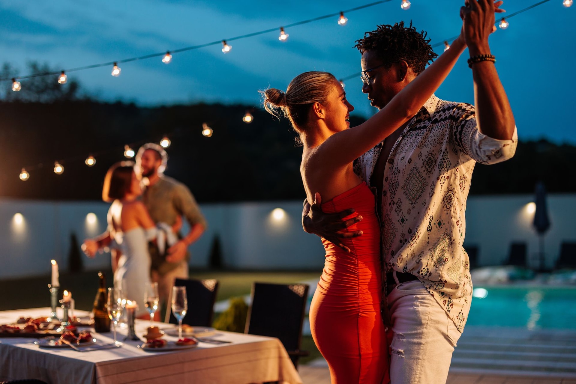 couple danving at island party