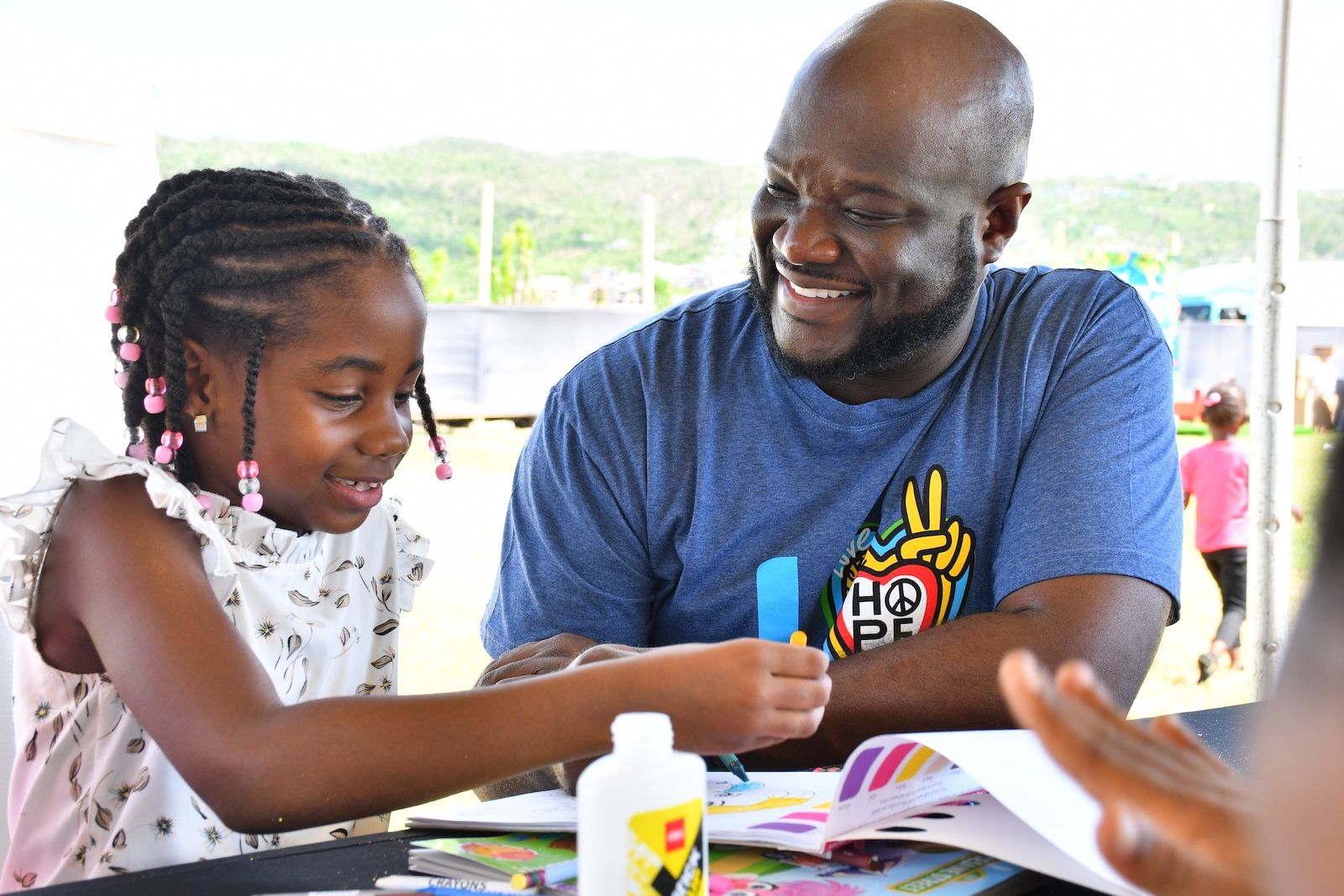 O-Brian-Heron--General-Manager-of-Sandals-South-Coast--connects-with-a-young-toy-drive-recipient-during-a-special-day-focused-on-giving-back-to-the-Westmoreland-community.