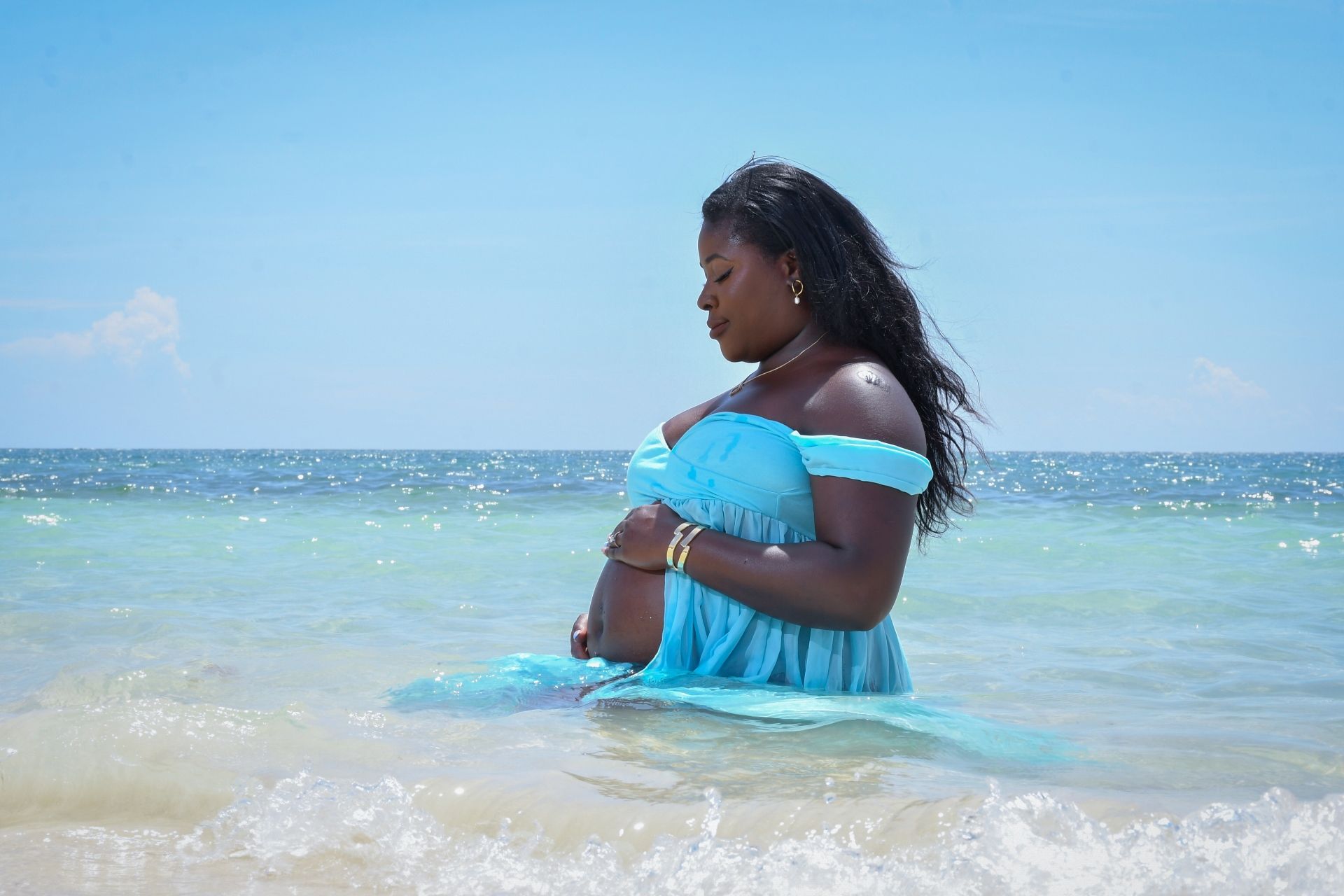 Mom-to-be enjoying the ocean during a relaxing babymoon at Sandals Jamaica