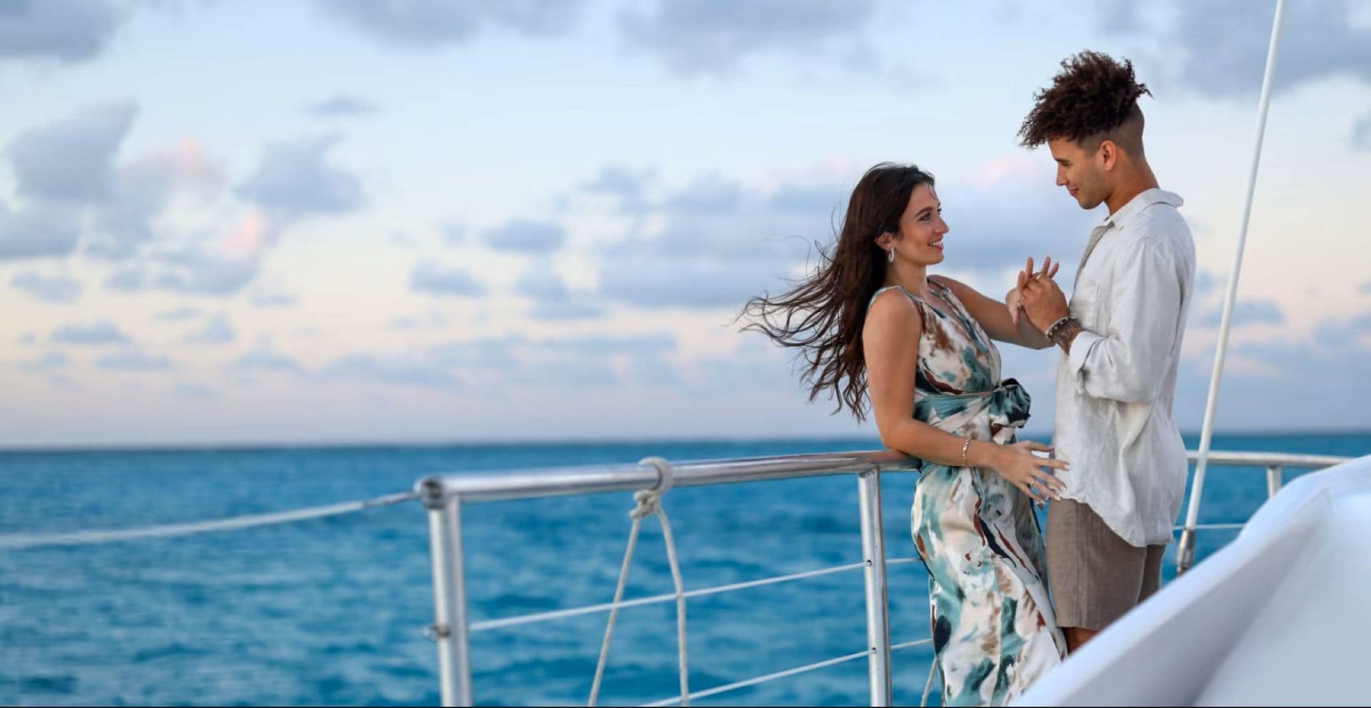 Couple enjoying sunset catamaran cruise in the Caribbean