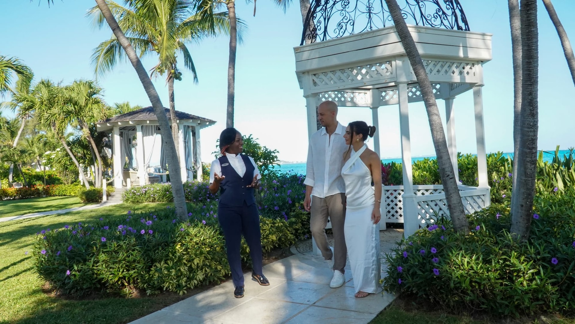 Sandals Resorts staff member talking to man and wife