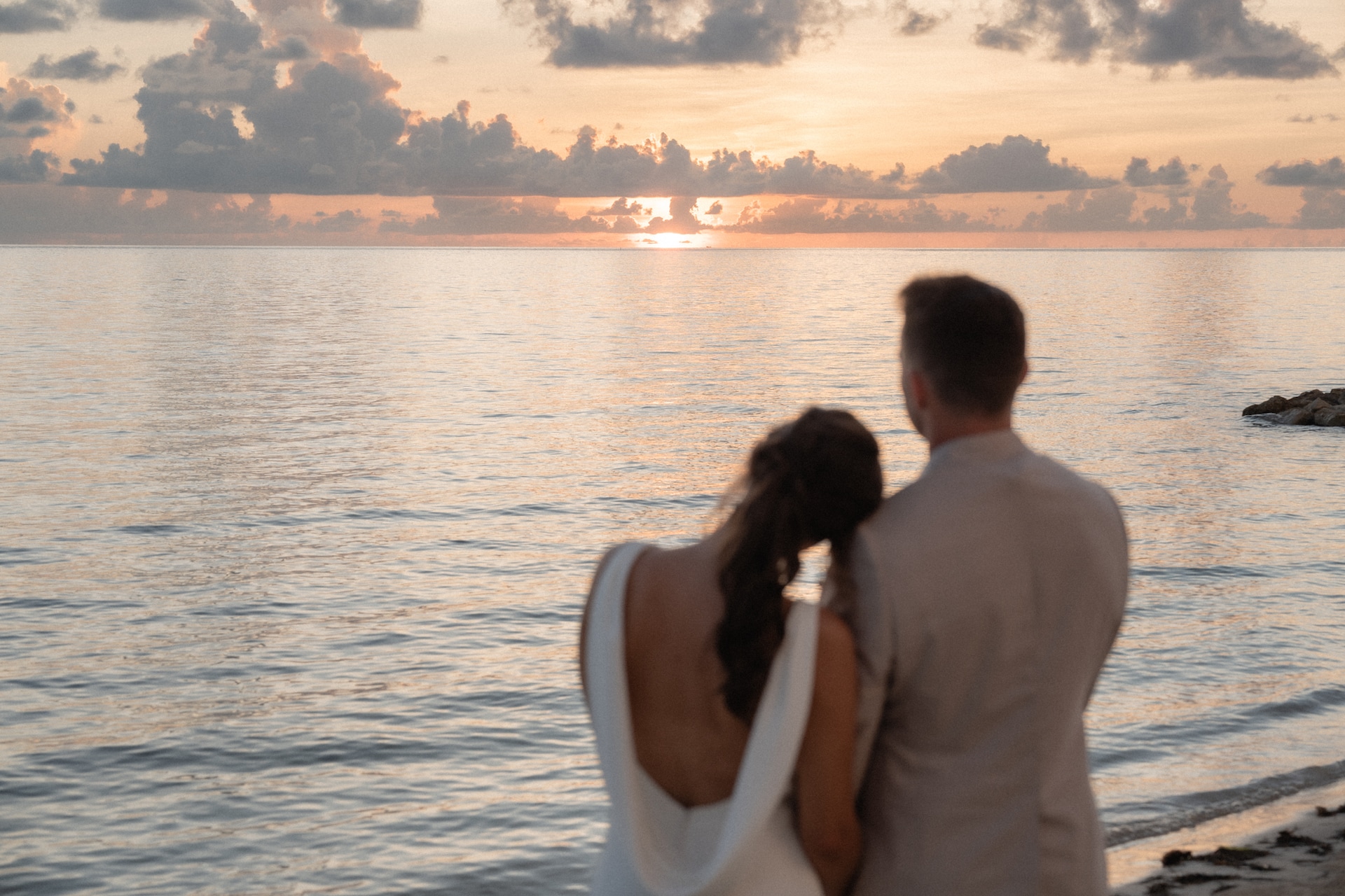 Alex & Don overlooking the ocean after their wedding