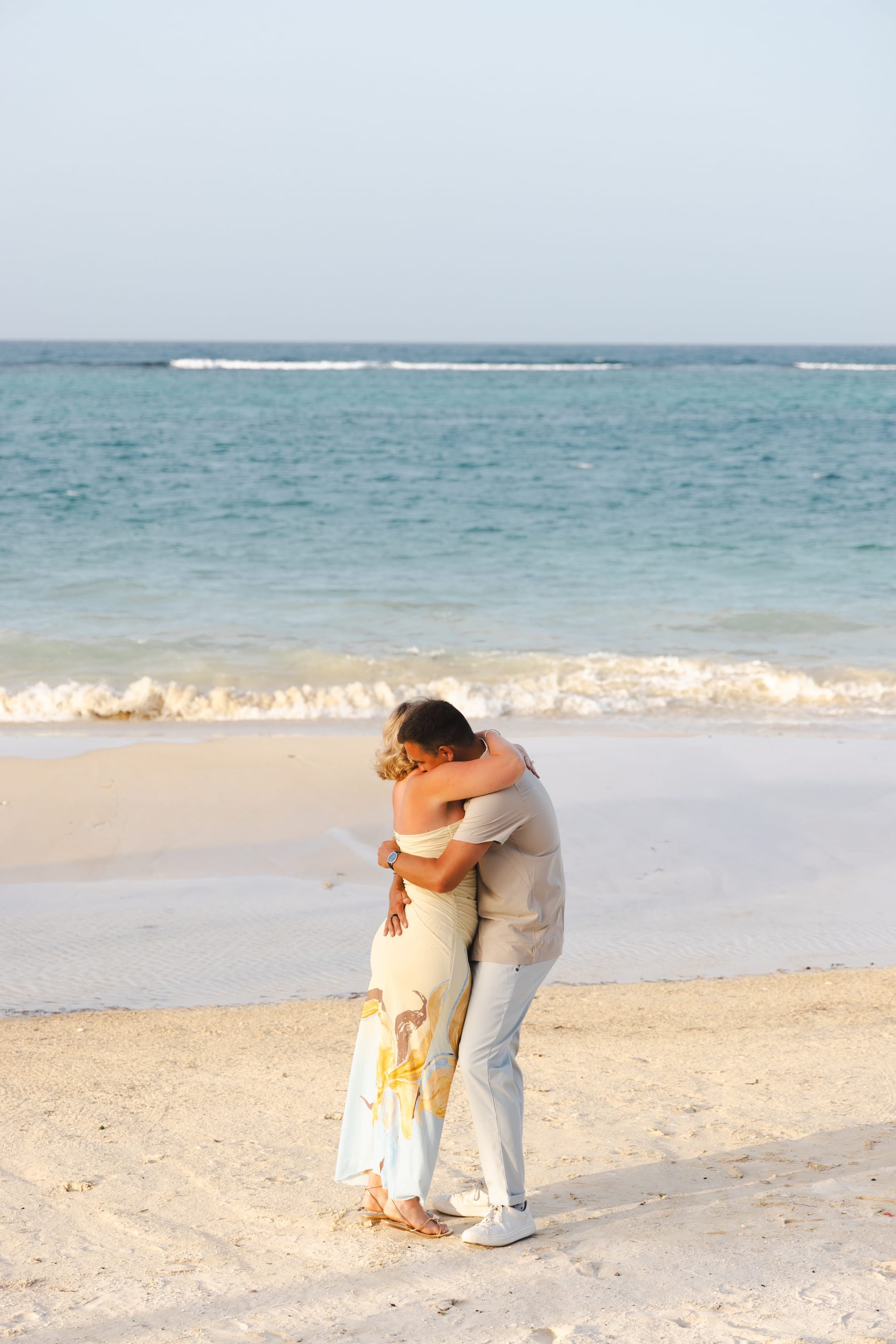 Justin and Fallon embrace on the beach after he proposes