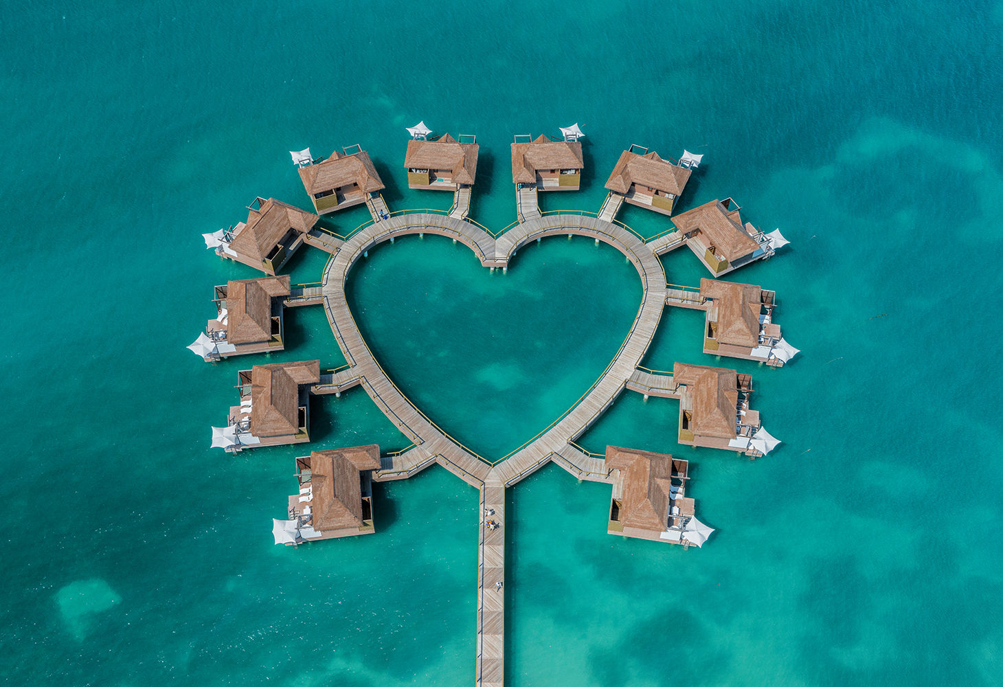 overwater bungalows in the shape of a heart in jamaica