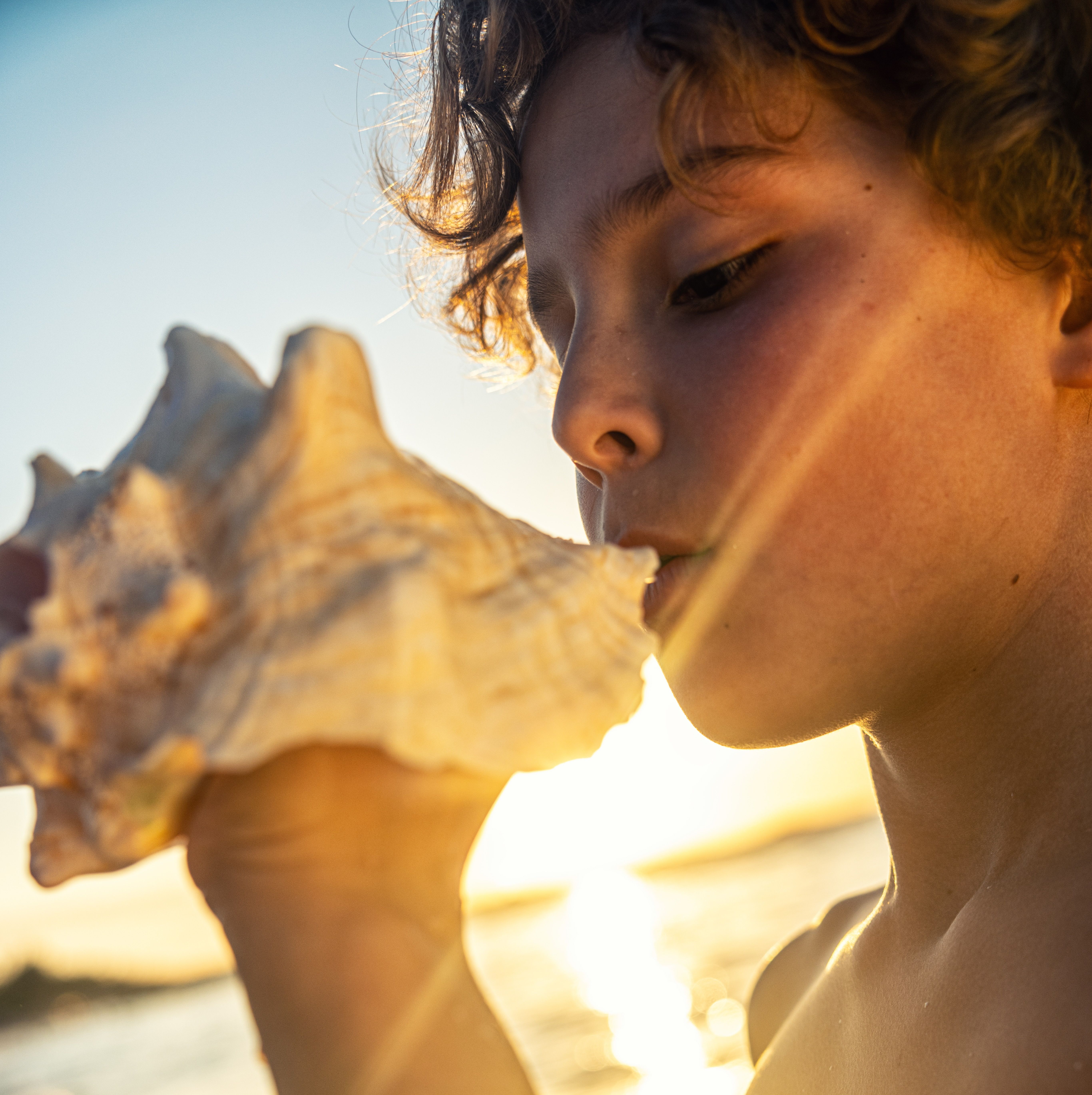 BTC-Lifestyle-Boy-Seashell-Sunset.jpg